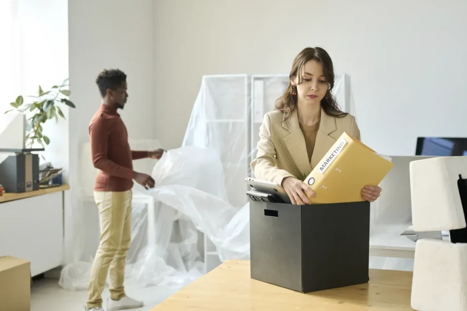 Businesswoman packing documents and files into a box for storage